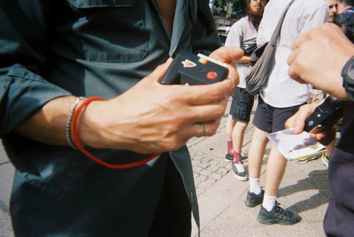 Participants sharing Polaroid Go cameras during the first PolaWalk in Berlin