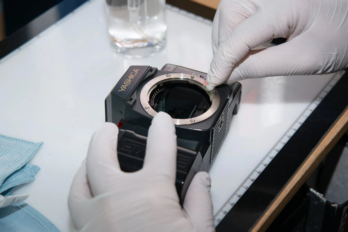 Analog film camera before careful cleaning and inspection in Berlin
