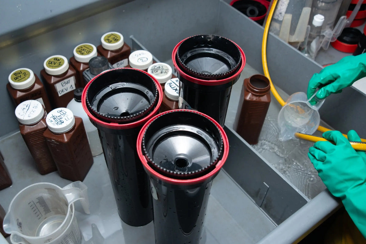 Several developing tanks and chemistry bottles on the laboratory bench