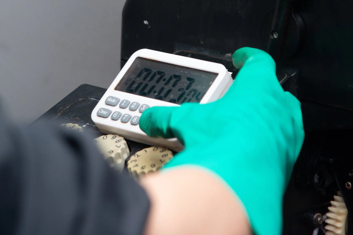 Technician using a timer during film development