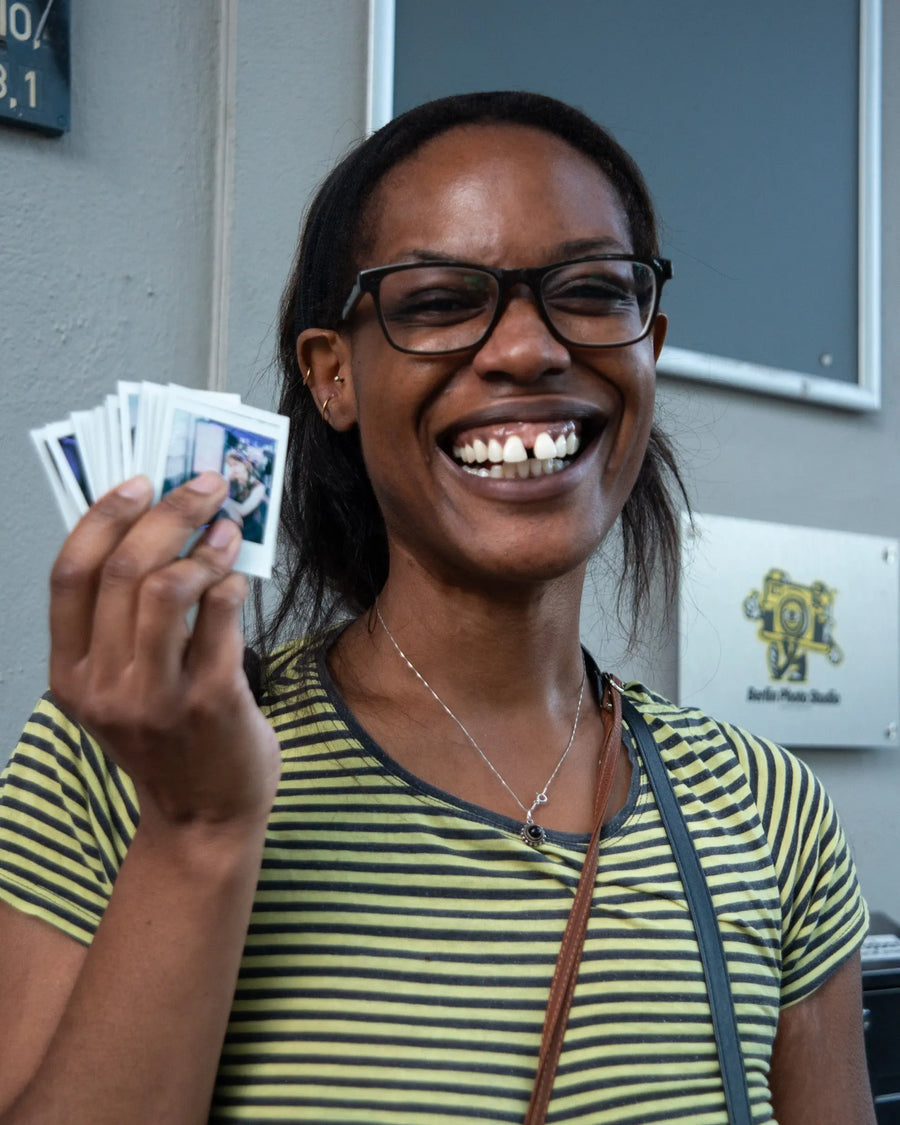 Smiling Polawalk participant holding an instant print