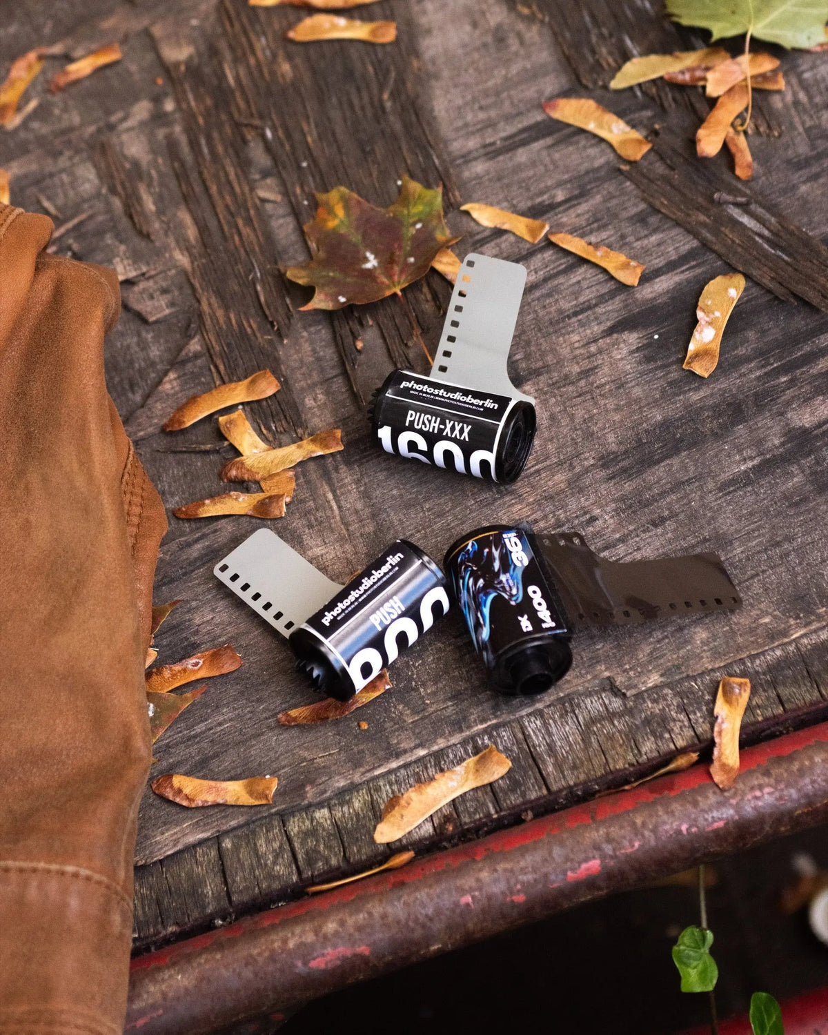 Film rolls with visible ISO ratings on an outdoor bench