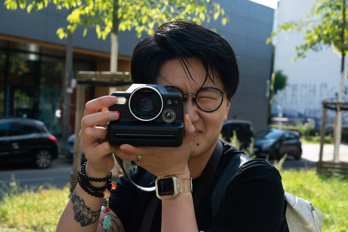 Participant taking a photograph with an instant camera