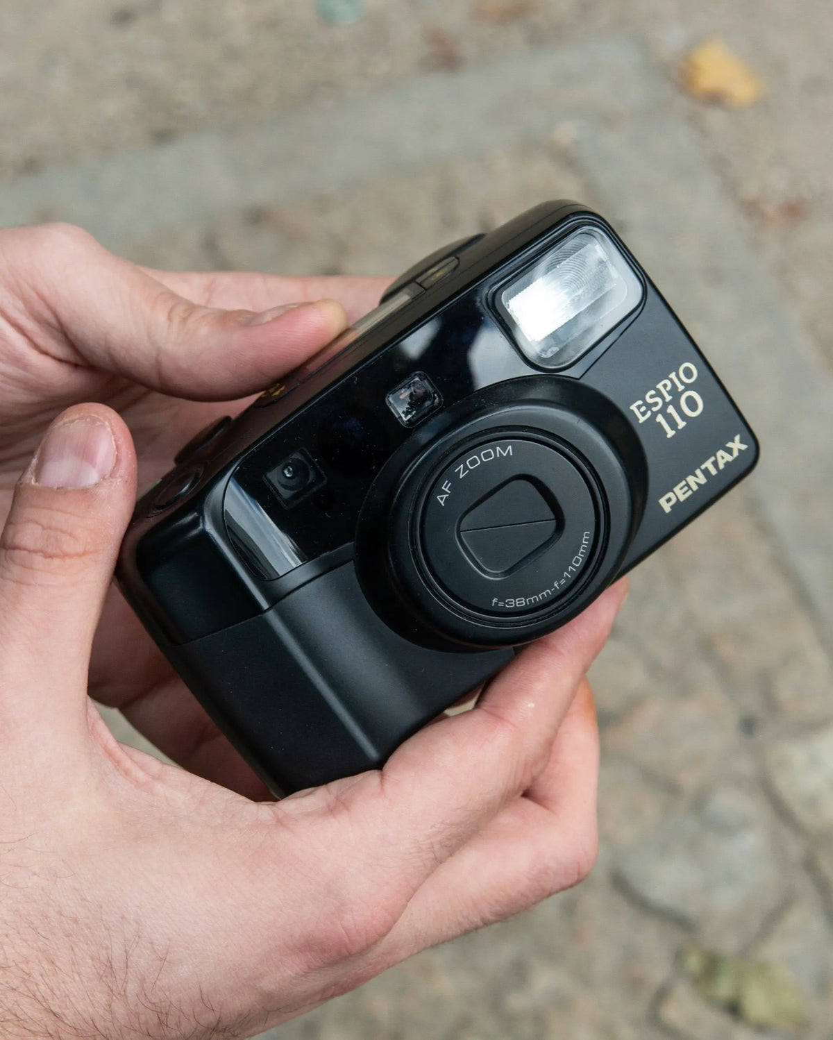 Close-up of a compact film camera and its lens