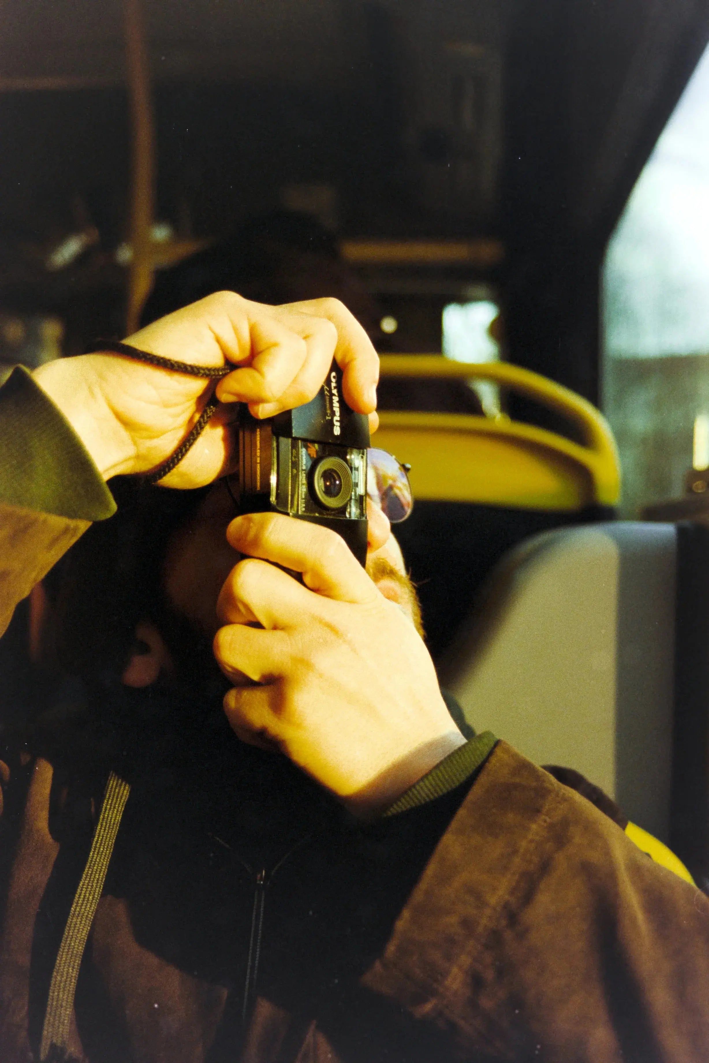 Photographer using a compact film camera during a Berlin Photo Studio collaboration