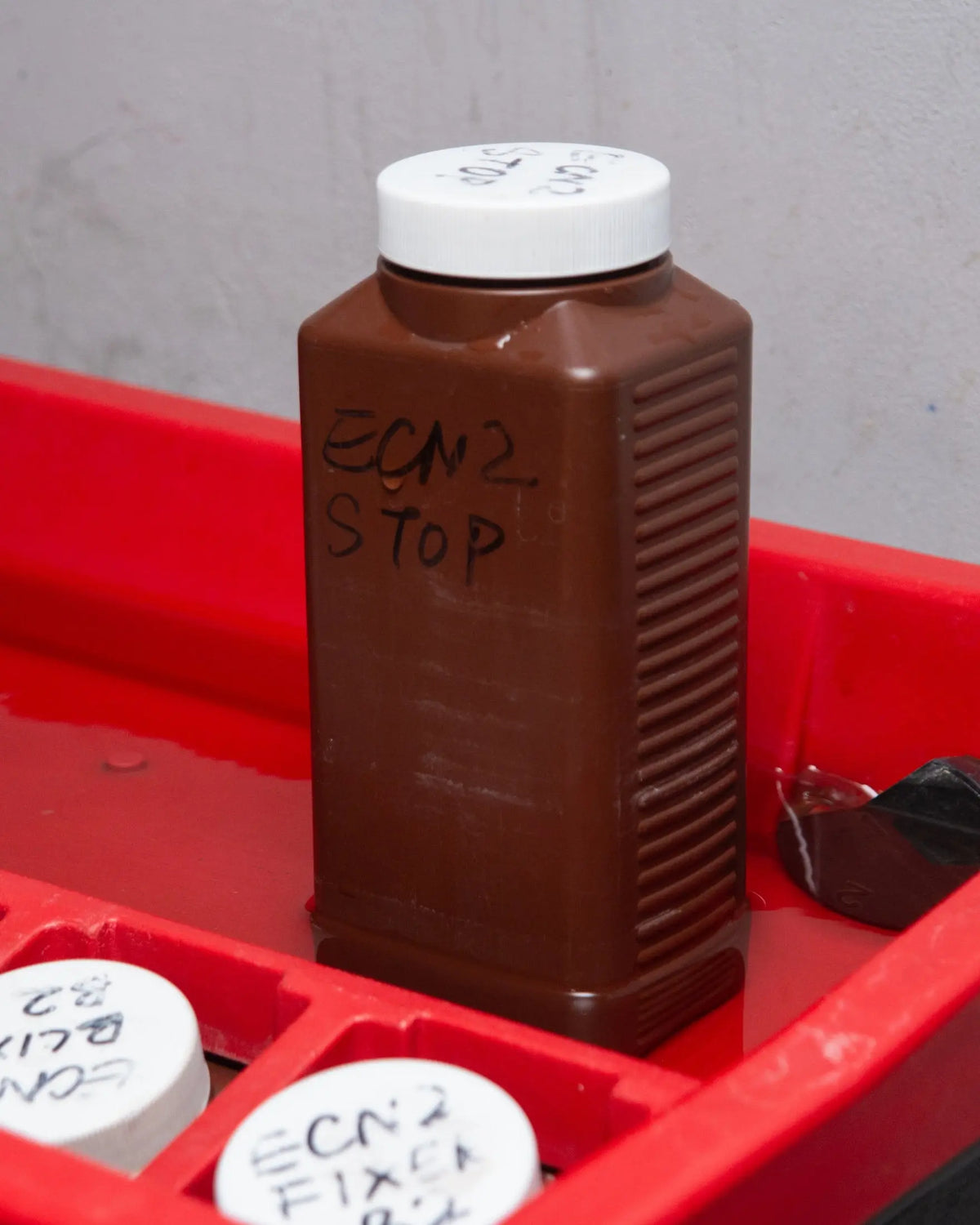 ECN-2 stop bath bottle at the development station at Berlin Photo Studio