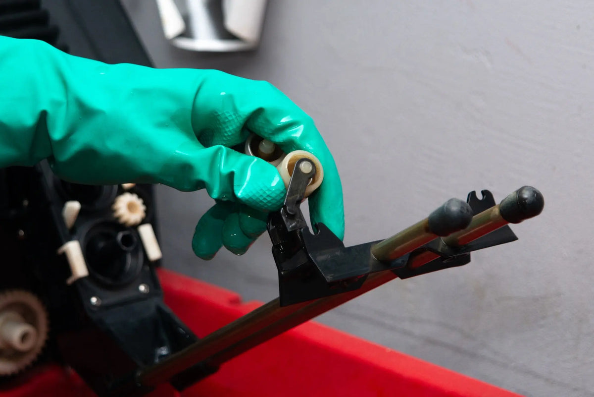 Gloved hand adjusting the JOBO tank support rollers at Berlin Photo Studio