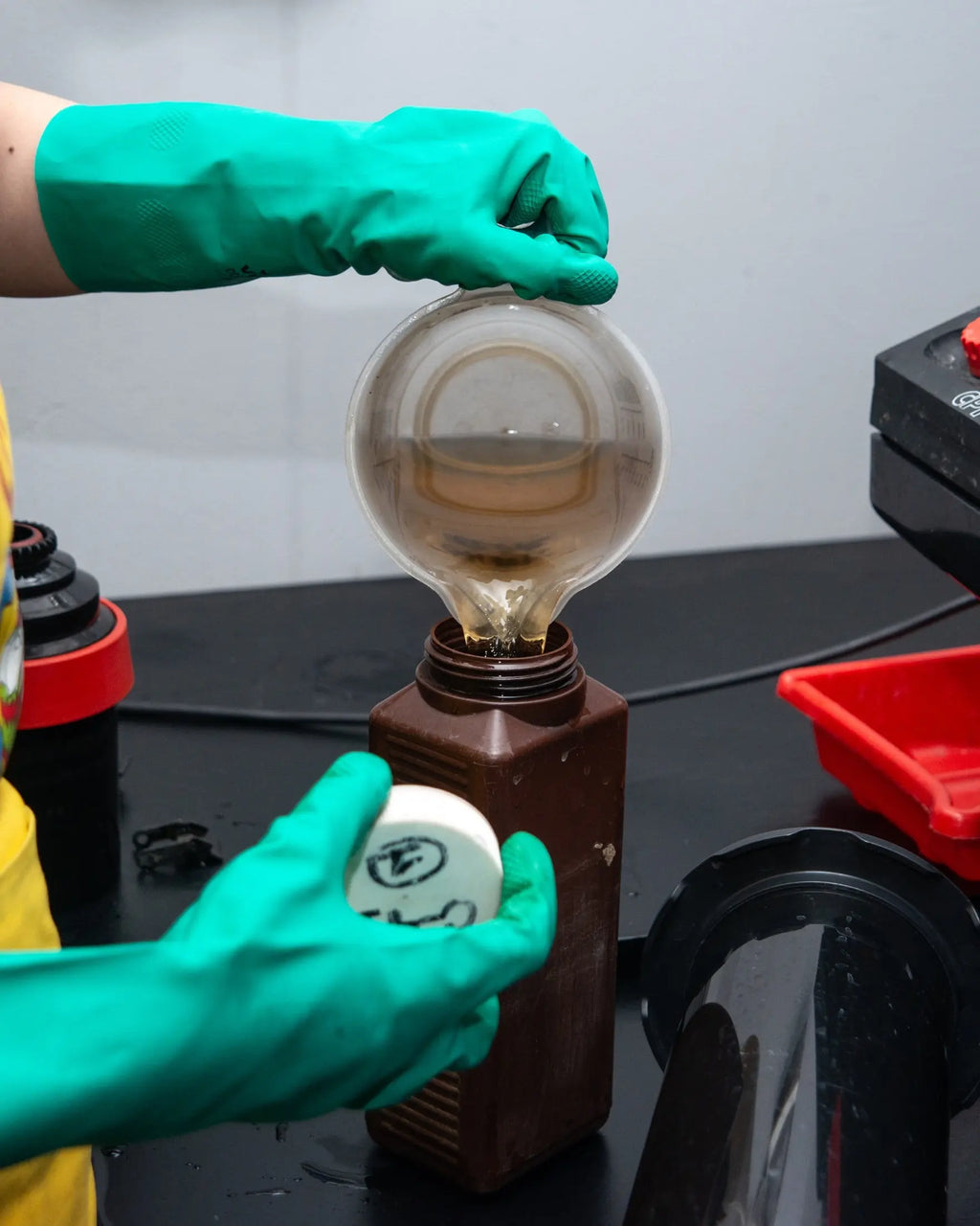 Measured processing solution being returned to a labelled bottle at Berlin Photo Studio